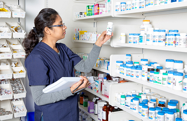 Female student practises inventory in the pharmacy lab